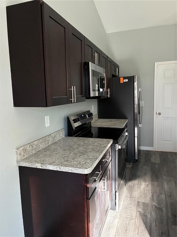 13033 Southwest 82nd Ave Road Ocala, FL 34473 - Photo 12 of 27 a kitchen with stainless steel appliances granite countertop a sink stove and refrigerator