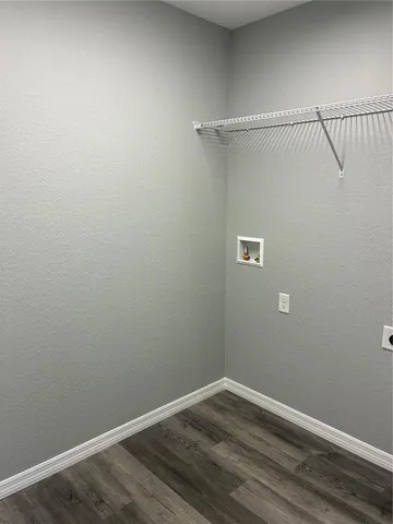 a view of wooden floor and windows in a room