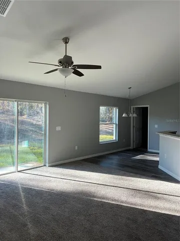 a bathroom with a granite countertop toilet and a bath tub