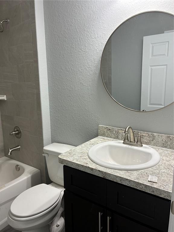 13033 Southwest 82nd Ave Road Ocala, FL 34473 - Photo 22 of 27 a bathroom with a sink a toilet and a mirror