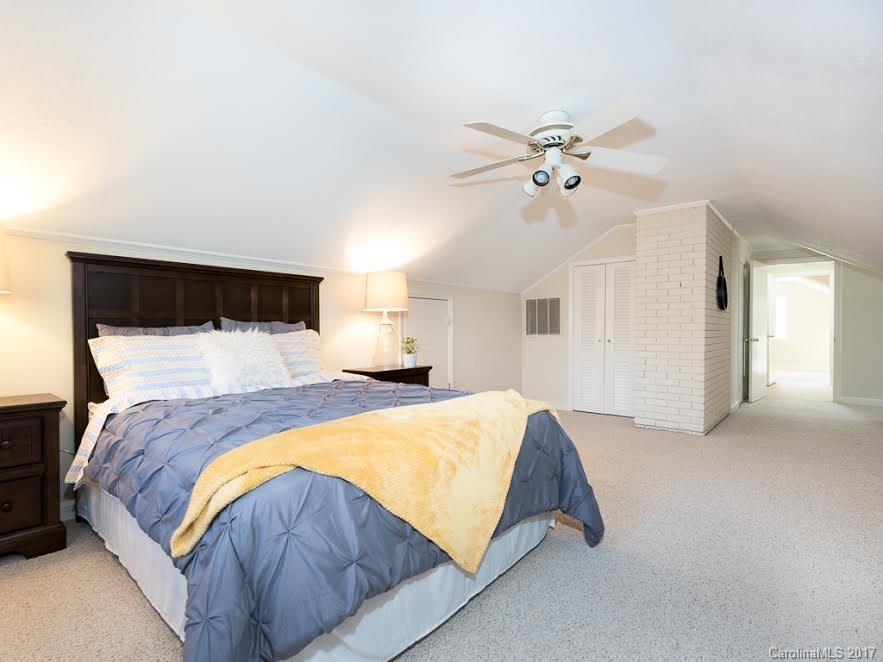 5600 Robinhood Road Charlotte, NC 28211 - Photo 11 of 22 a bed sitting in a bedroom and chandelier