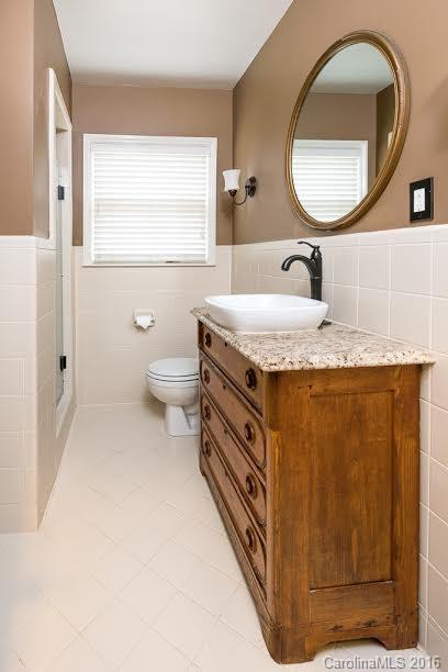 5600 Robinhood Road Charlotte, NC 28211 - Photo 12 of 22 a bathroom with a granite countertop toilet sink and mirror