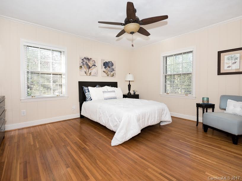 5600 Robinhood Road Charlotte, NC 28211 - Photo 13 of 22 a bedroom with a large bed chandelier and a window