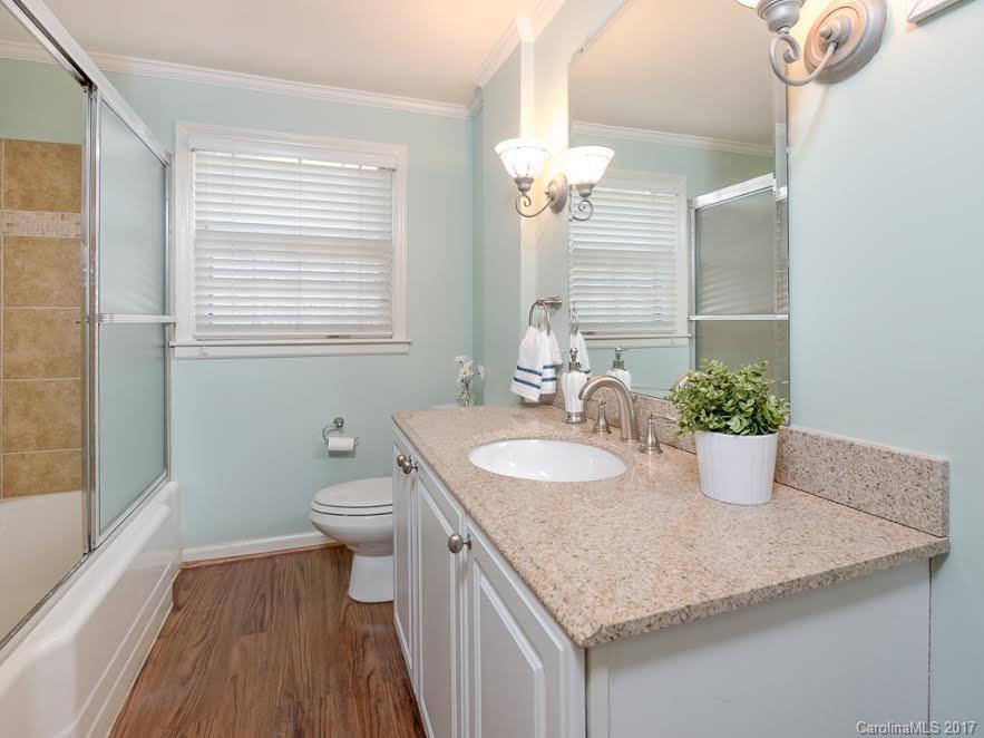 5600 Robinhood Road Charlotte, NC 28211 - Photo 15 of 22 a bathroom with a granite countertop sink a toilet and a large mirror