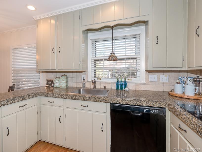 5600 Robinhood Road Charlotte, NC 28211 - Photo 4 of 22 a kitchen with granite countertop stainless steel appliances white cabinets sink and window