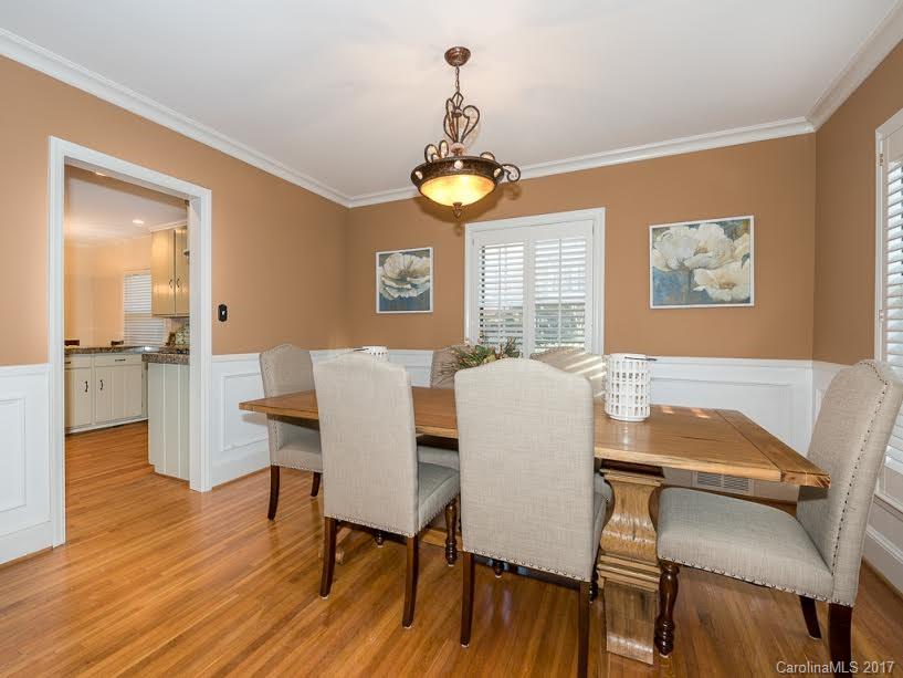 5600 Robinhood Road Charlotte, NC 28211 - Photo 5 of 22 a view of a dining room with furniture wooden floor and a chandelier