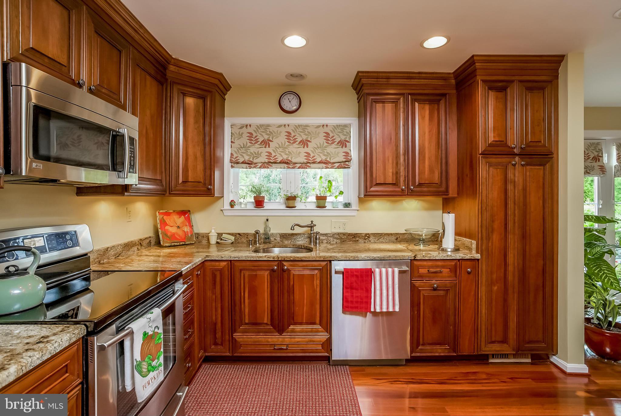 9407 Oak White Road Baltimore, MD 21236 - Photo 10 of 30 a kitchen with stainless steel appliances granite countertop a stove a sink dishwasher and a microwave