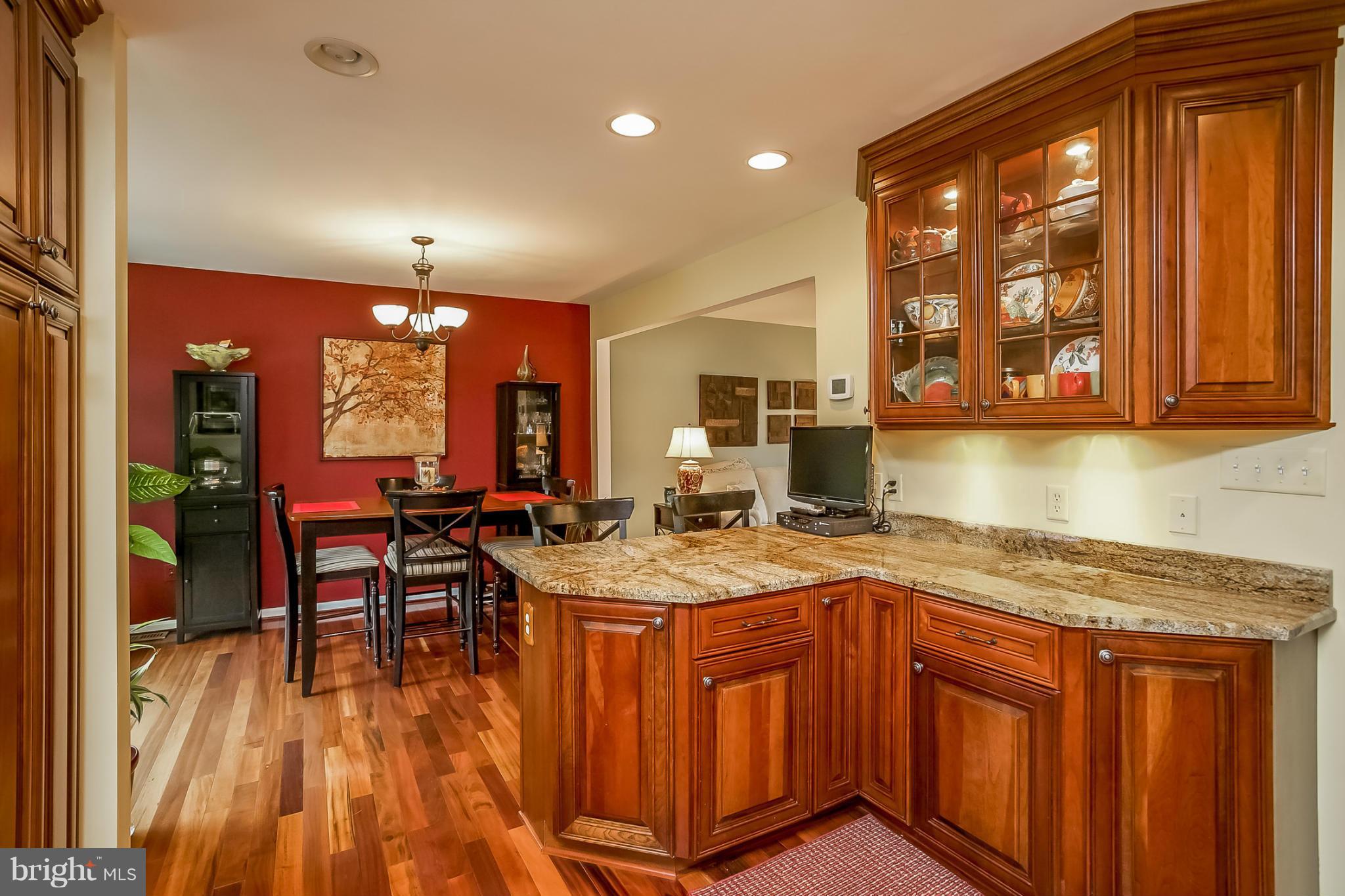 9407 Oak White Road Baltimore, MD 21236 - Photo 11 of 30 a kitchen with a stove a sink and a wooden cabinets