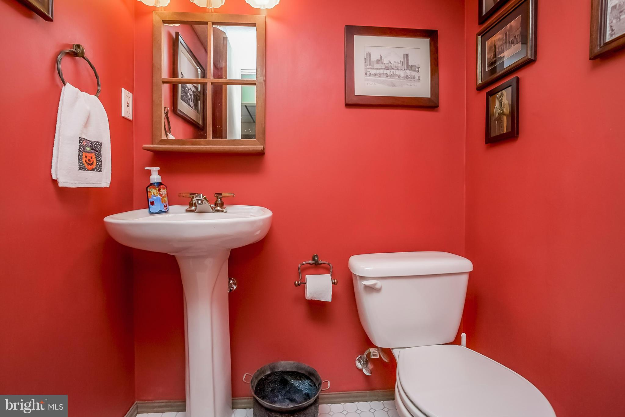 9407 Oak White Road Baltimore, MD 21236 - Photo 18 of 30 a bathroom with a toilet sink and mirror