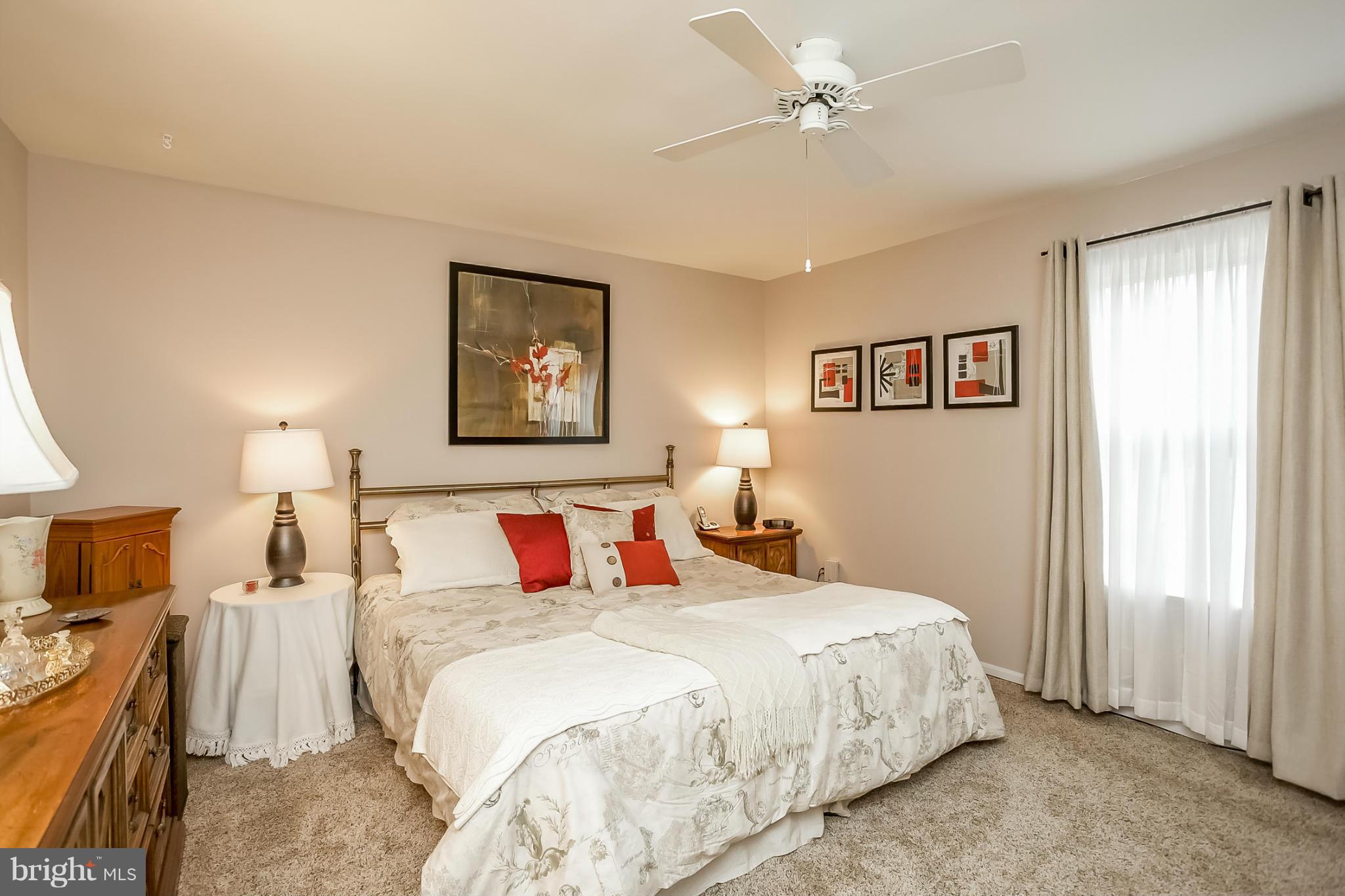 9407 Oak White Road Baltimore, MD 21236 - Photo 19 of 30 a bedroom with a large bed and a chandelier
