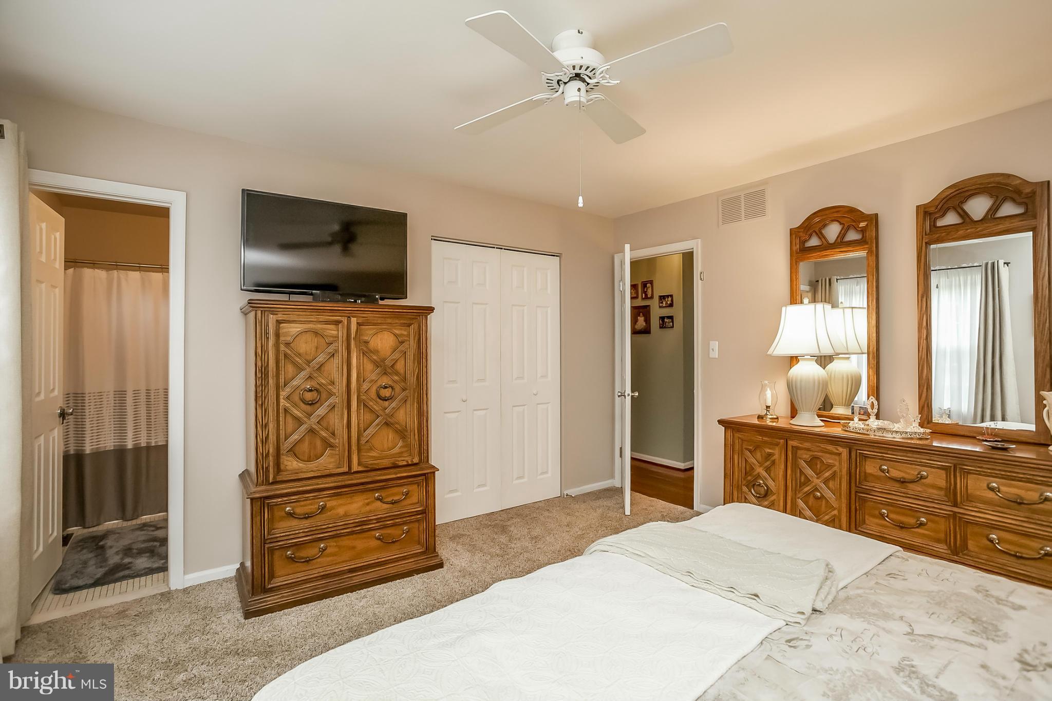 9407 Oak White Road Baltimore, MD 21236 - Photo 20 of 30 a spacious bedroom with a bed and a television