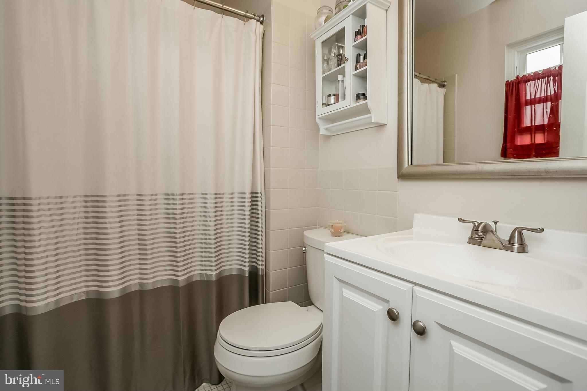 9407 Oak White Road Baltimore, MD 21236 - Photo 21 of 30 a bathroom with a sink and a toilet