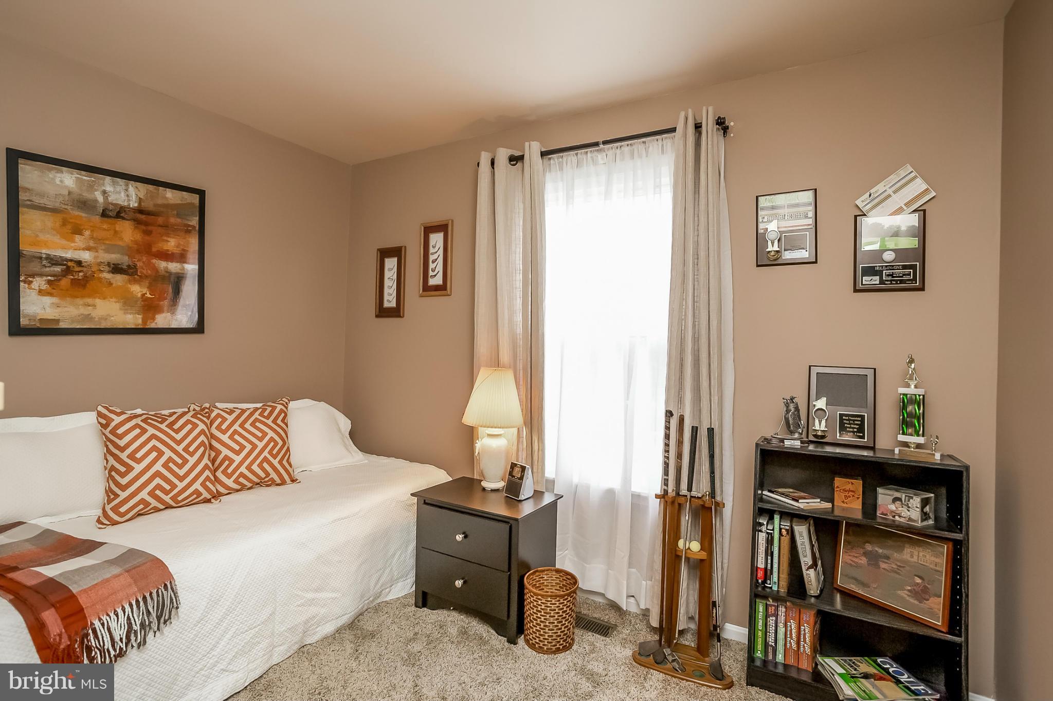 9407 Oak White Road Baltimore, MD 21236 - Photo 22 of 30 a bedroom with a bed and wooden floor