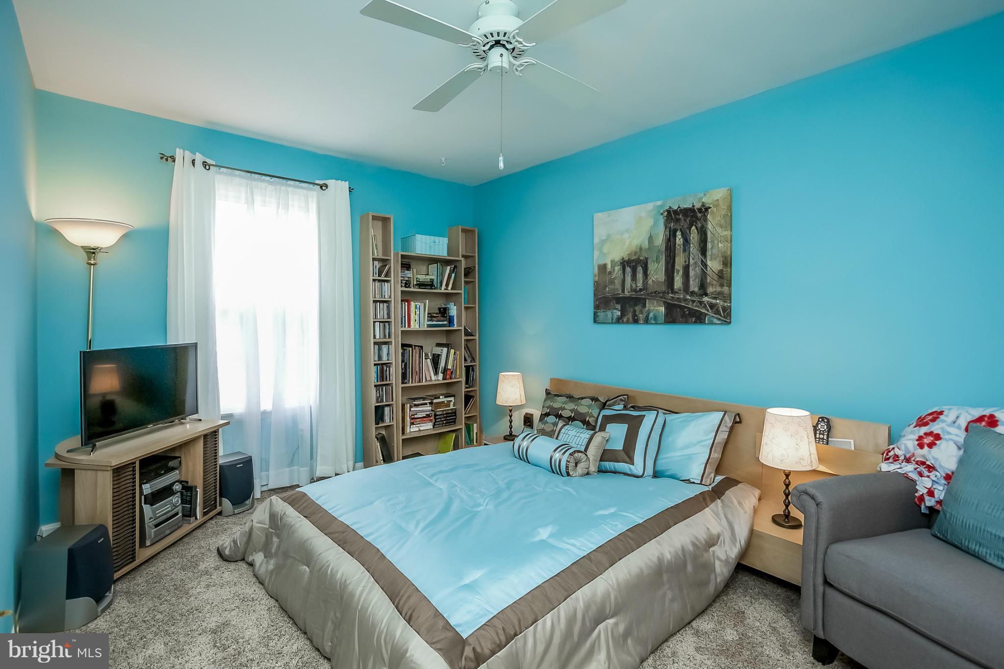 9407 Oak White Road Baltimore, MD 21236 - Photo 23 of 30 a bedroom with a bed and a flat screen tv