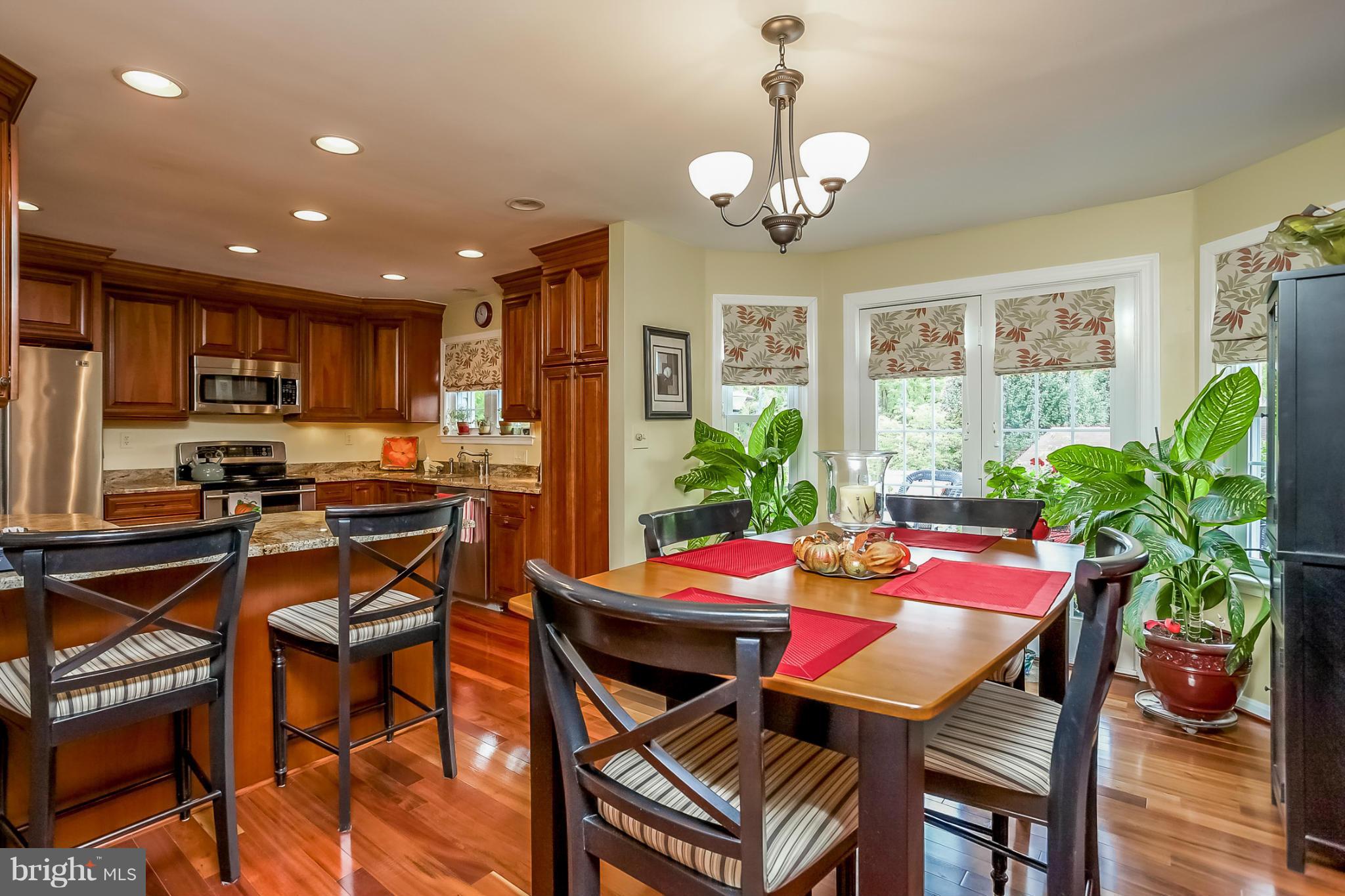 9407 Oak White Road Baltimore, MD 21236 - Photo 6 of 30 a view of a dining room with furniture window and wooden floor