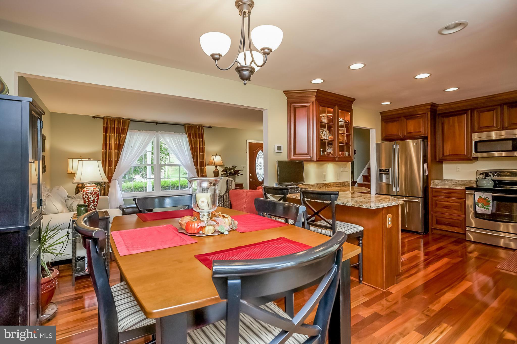 9407 Oak White Road Baltimore, MD 21236 - Photo 7 of 30 a view of a dining room with furniture window and wooden floor
