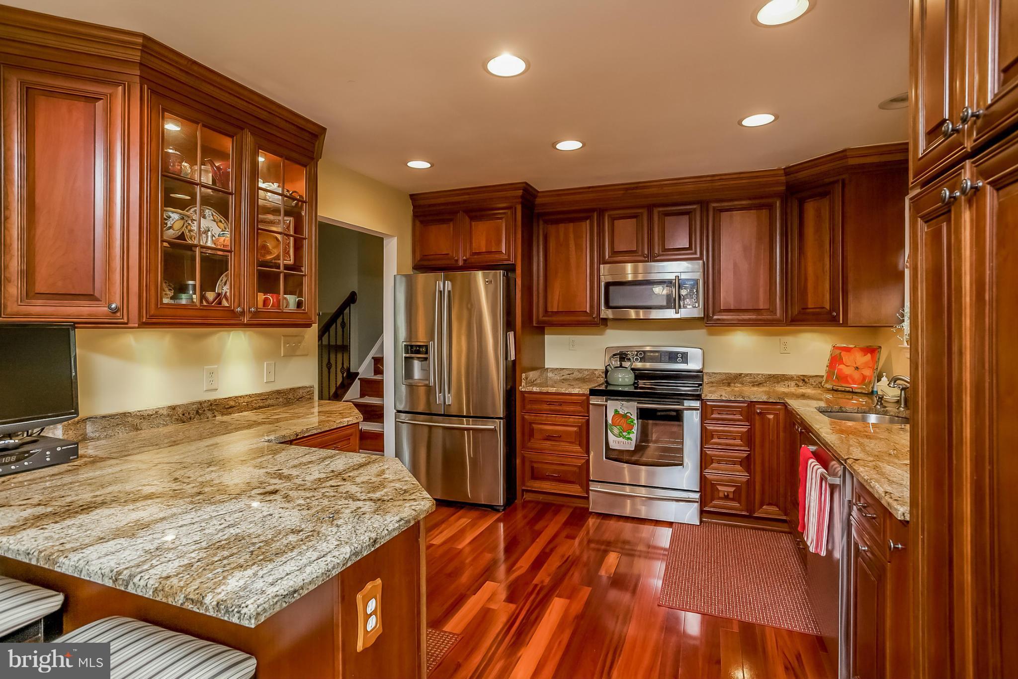 9407 Oak White Road Baltimore, MD 21236 - Photo 9 of 30 a kitchen with stainless steel appliances granite countertop a refrigerator stove top oven and sink
