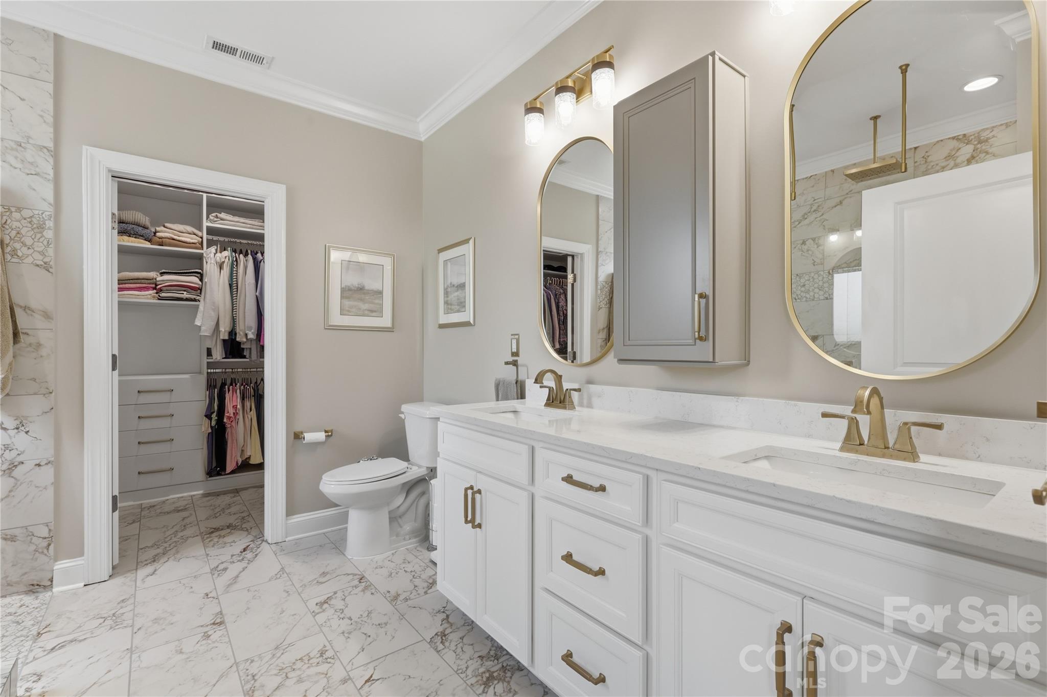 3023 Eagle Ridge Lane Indian Trail, NC 28079 - Photo 26 of 47 a bathroom with a toilet a double vanity sink and a mirror