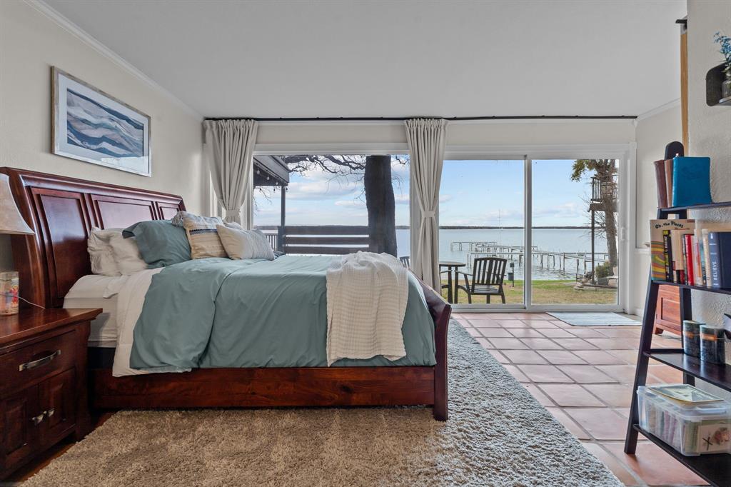 a bedroom with a bed and large window