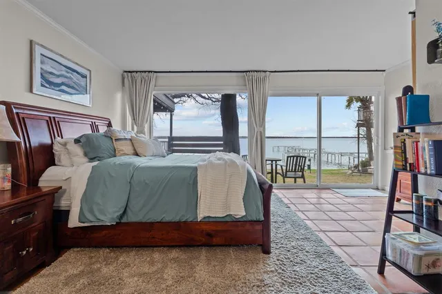 a bedroom with a bed and large window