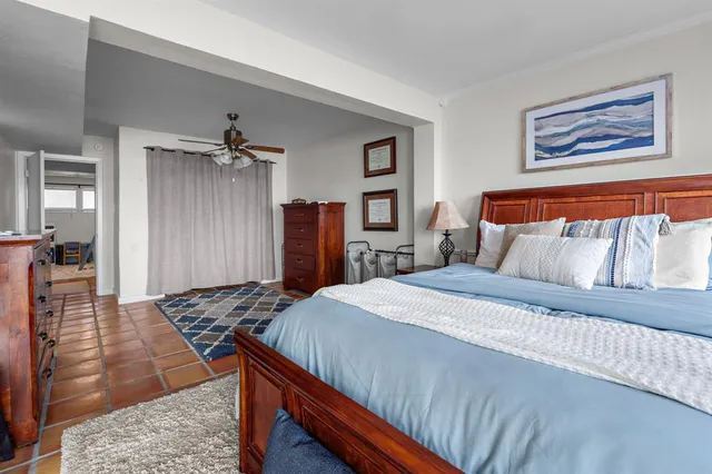 a bedroom with bed and wooden floor