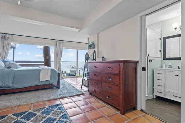 a bathroom with a granite countertop sink a mirror and shower