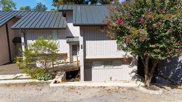 an aerial view of a house with outdoor space and lake view