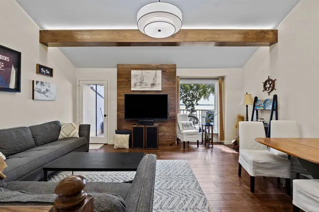 a living room with furniture a rug and a flat screen tv
