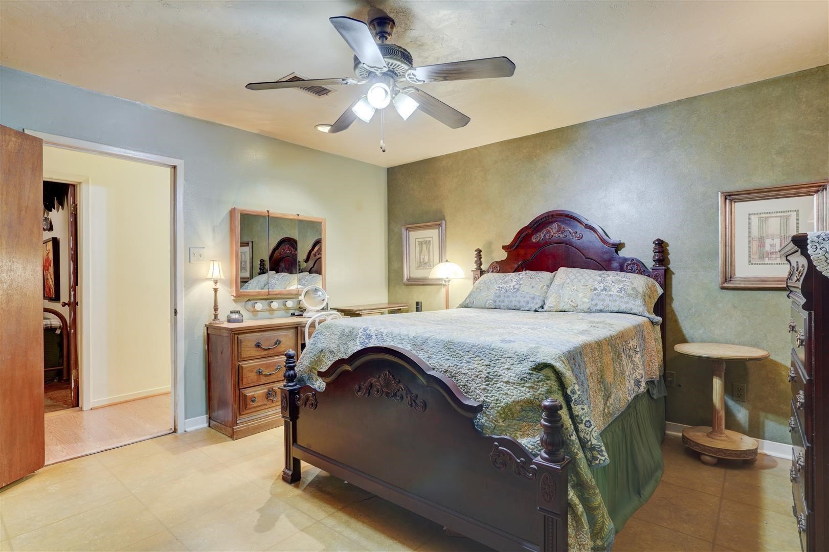 15771 1st Street Splendora, TX 77372 - Photo 18 of 47 a bedroom with a bed and a chandelier