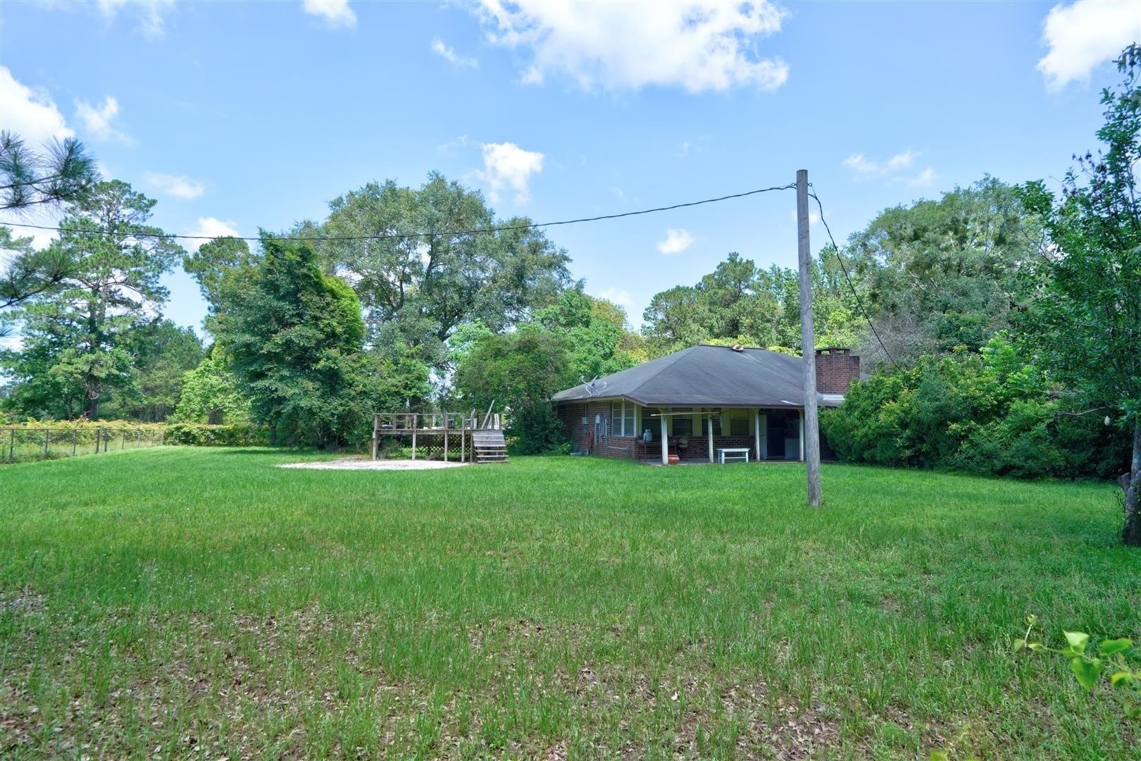 15771 1st Street Splendora, TX 77372 - Photo 26 of 47 a view of a house with a yard