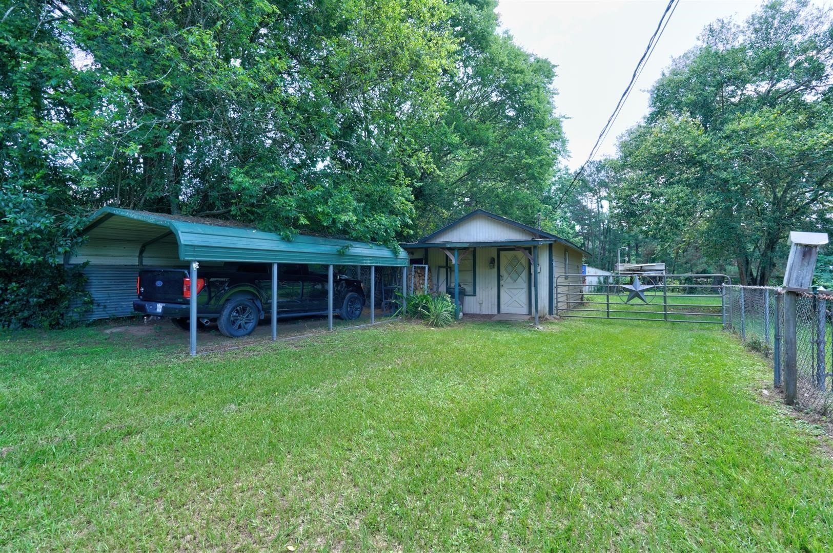 15771 1st Street Splendora, TX 77372 - Photo 28 of 47 a front view of a house with a garden