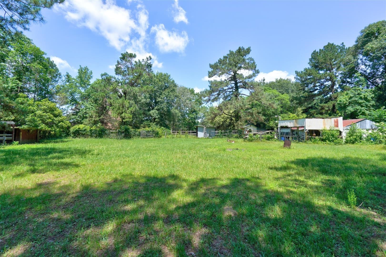 15771 1st Street Splendora, TX 77372 - Photo 34 of 47 a view of a garden with a house in the background