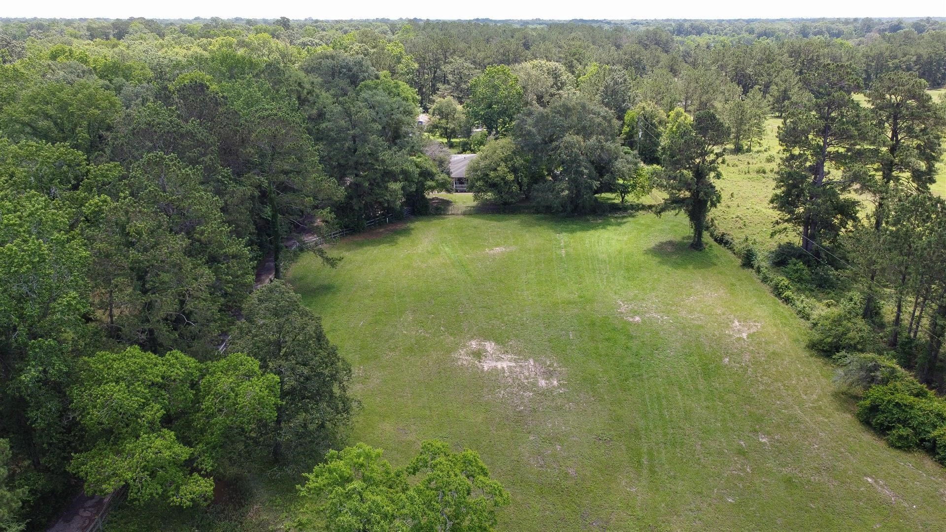 15771 1st Street Splendora, TX 77372 - Photo 40 of 47 a view of a lake with a yard