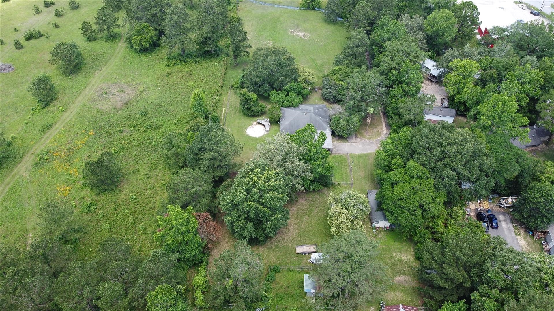 15771 1st Street Splendora, TX 77372 - Photo 46 of 47 an aerial view of residential house with outdoor space and trees all around