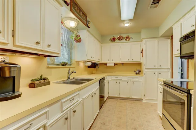 a kitchen with cabinets a sink and appliances