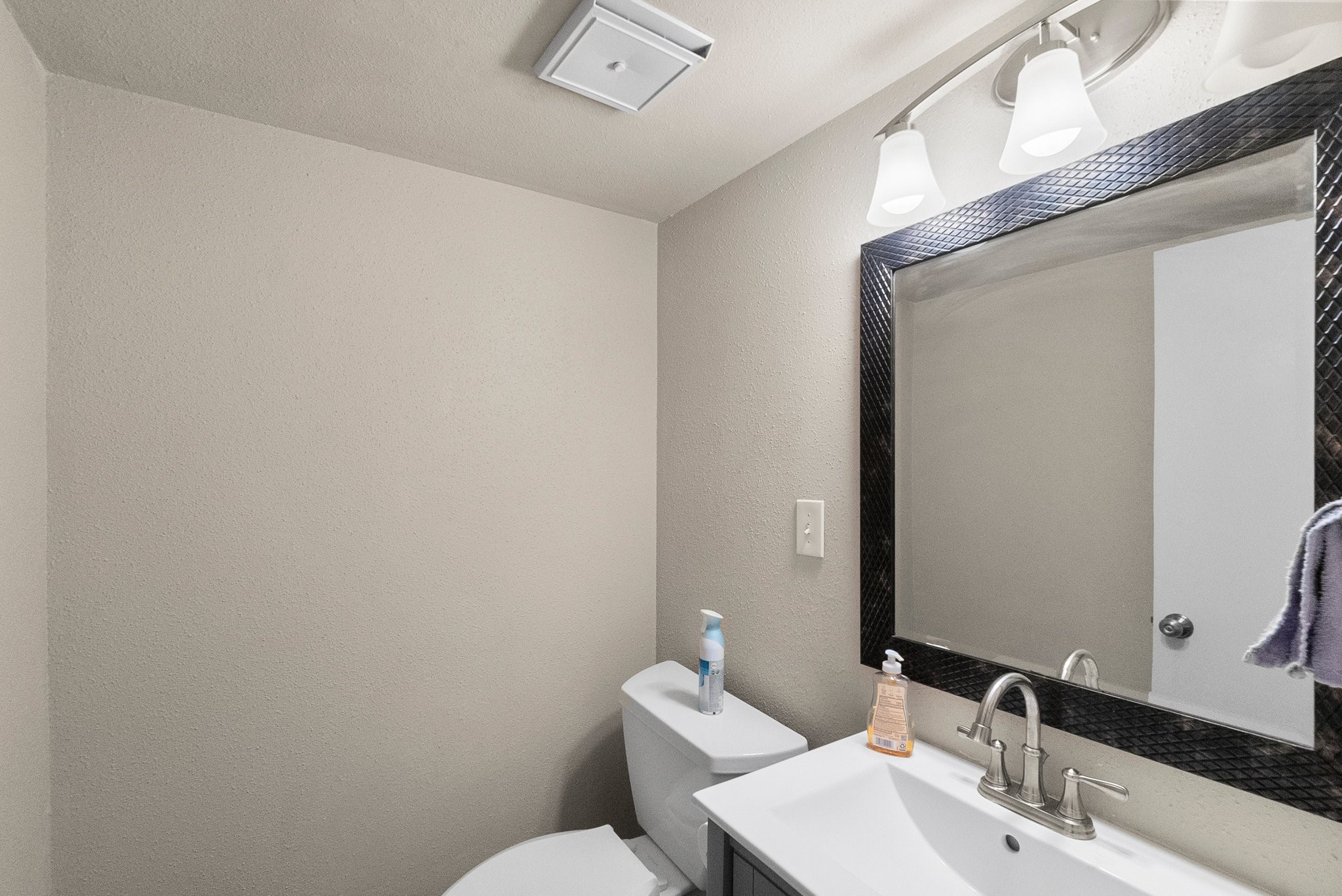 407 West Semands Street Conroe, TX 77301 - Photo 21 of 28 a bathroom with a sink mirror and toilet