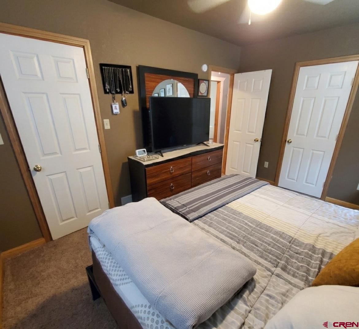 816 Main Street Manassa, CO 81141 - Photo 21 of 23 a bedroom with a bed and a flat screen tv