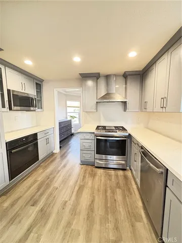 a kitchen with stainless steel appliances a stove a sink and a refrigerator