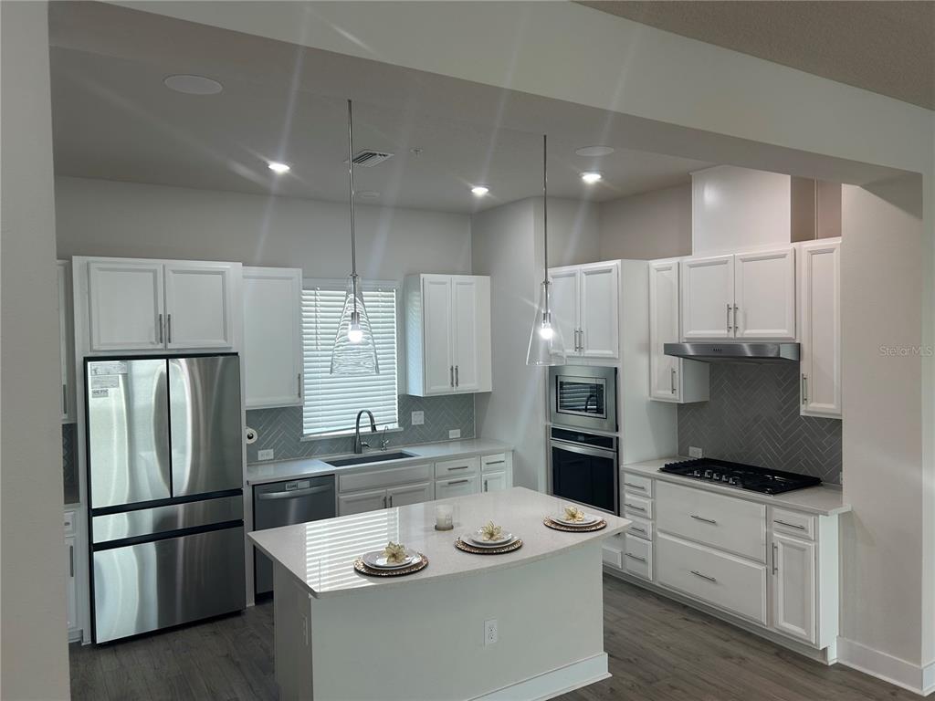 2511 North Grady Avenue, Unit 34 Tampa, FL 33607 - Photo 34 of 45 a kitchen with stainless steel appliances refrigerator stove microwave and cabinets
