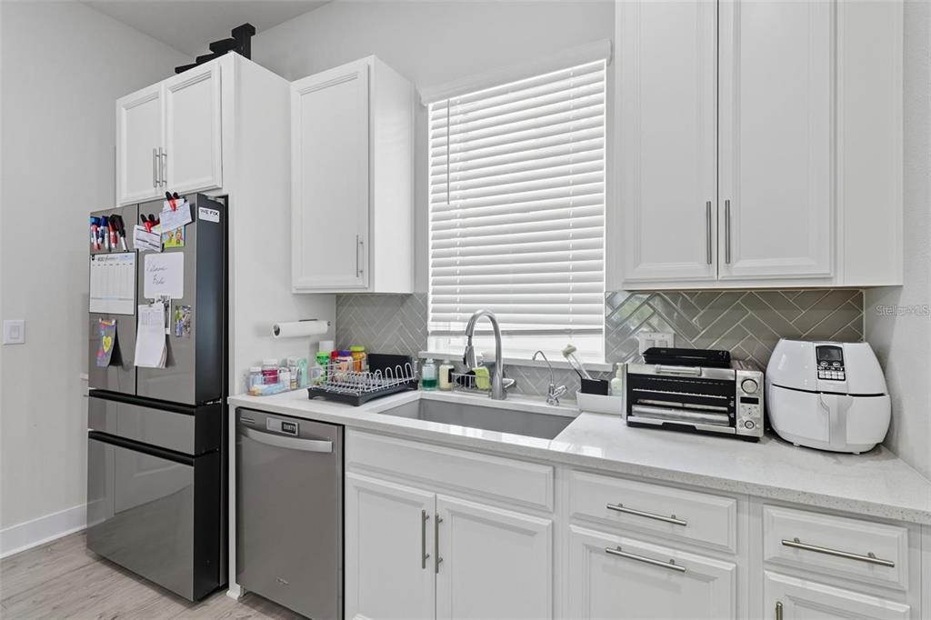 2511 North Grady Avenue, Unit 34 Tampa, FL 33607 - Photo 7 of 45 a kitchen with stainless steel appliances a refrigerator sink and cabinets