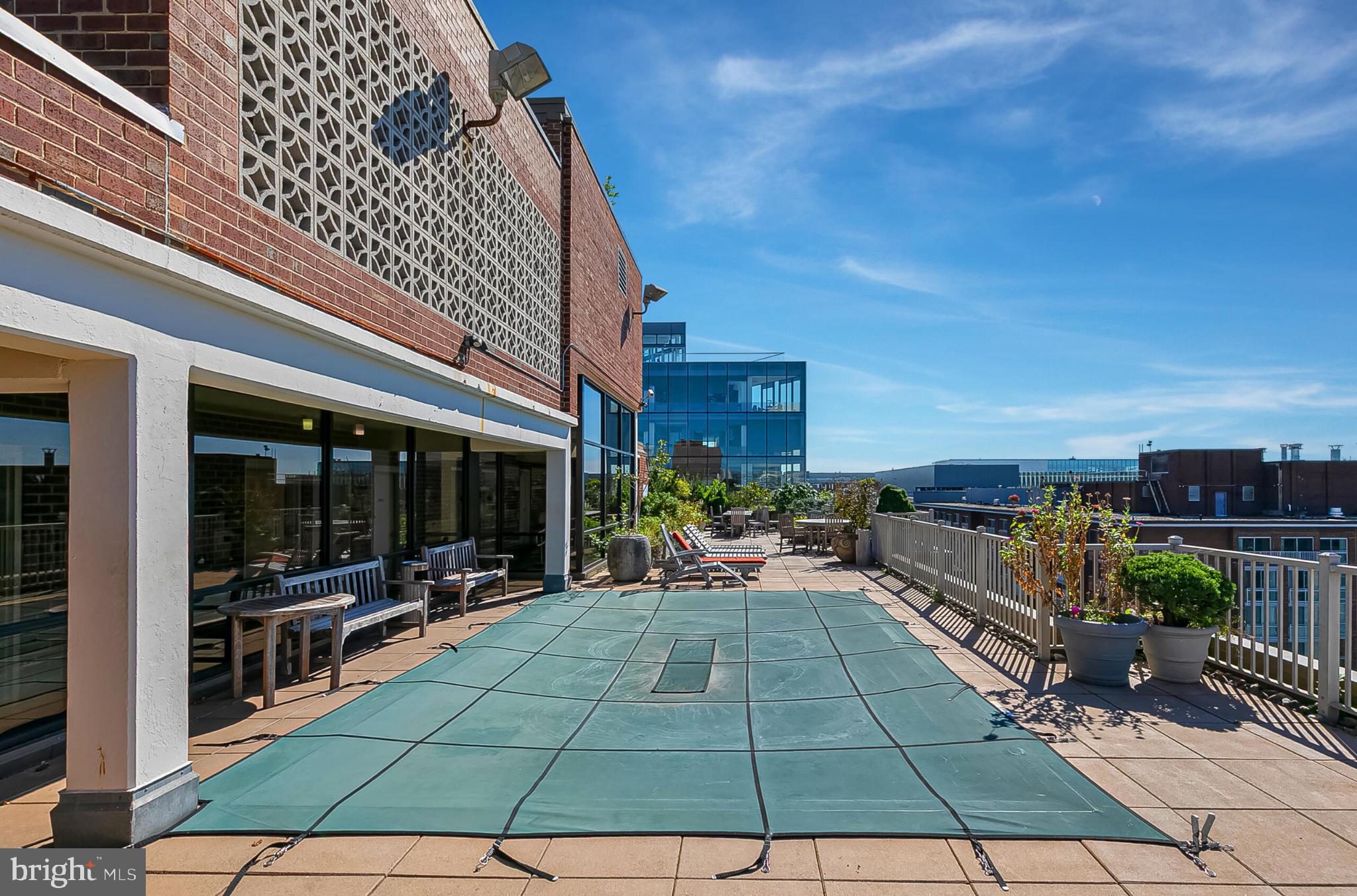 1301 20th Street Northwest, Unit 901 Washington, DC 20036 - Photo 13 of 25 a view of a patio with table and chairs a barbeque with wooden floor and fence