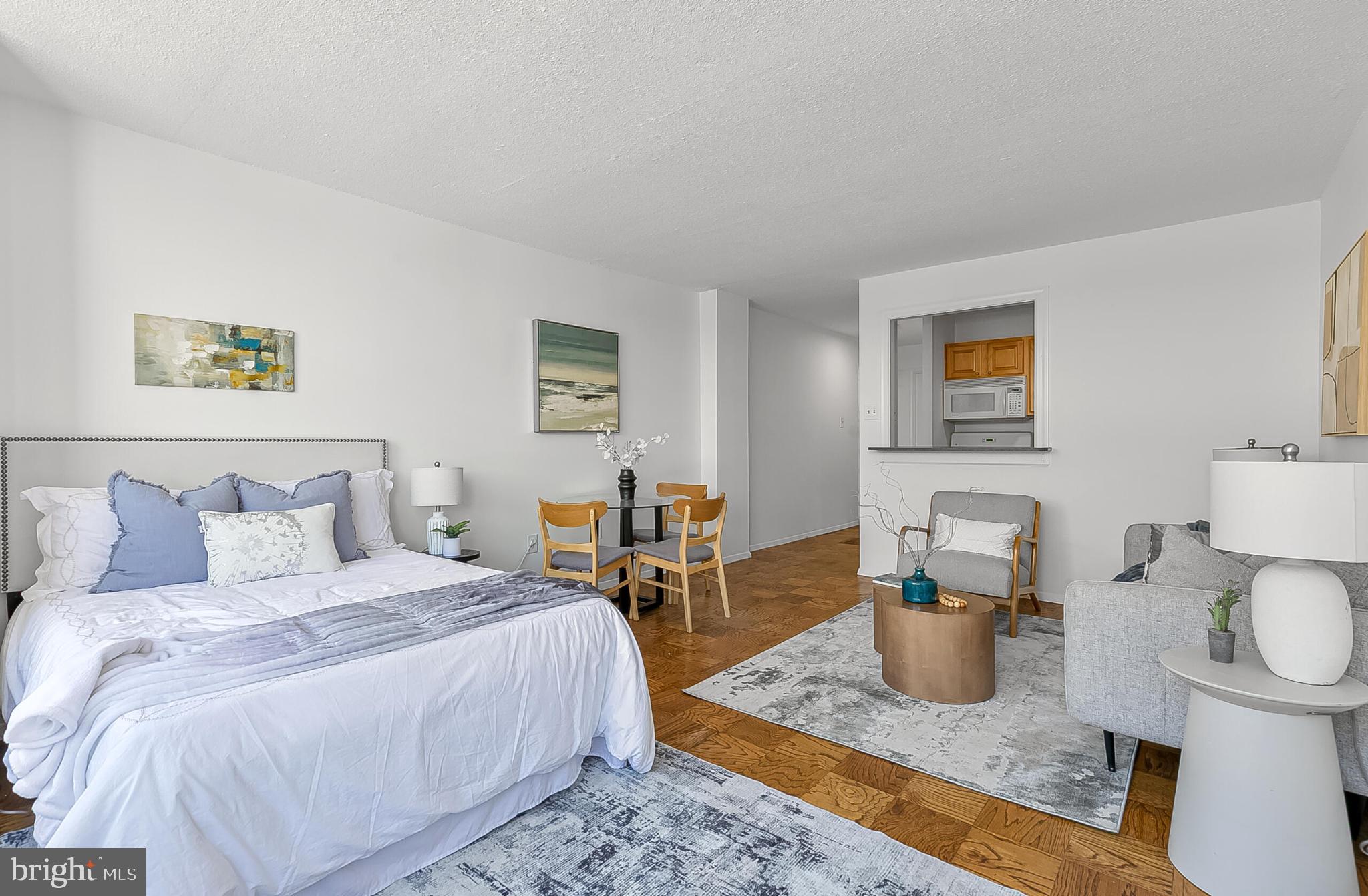 1301 20th Street Northwest, Unit 901 Washington, DC 20036 - Photo 9 of 25 a bedroom with a bed and a table in it