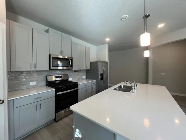 a kitchen with a sink a stove and microwave