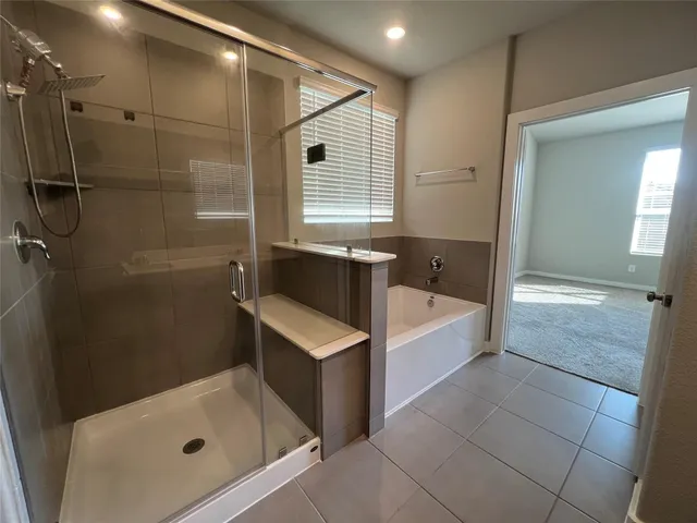a bathroom with a tub a toilet and a shower