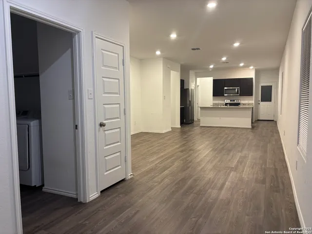 a view of a hallway with wooden floor