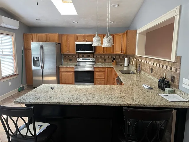 a bathroom with a granite countertop sink a mirror and vanity