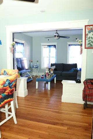 a living room with fireplace furniture and a wooden floor