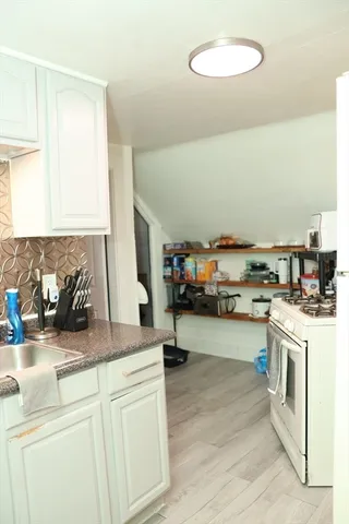 a bathroom with a sink a toilet and mirror