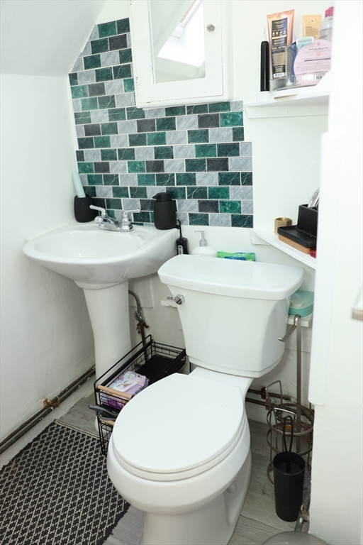 62-64 Whittier Street Springfield, MA 01108 - Photo 16 of 30 a bathroom with a sink a toilet and mirror