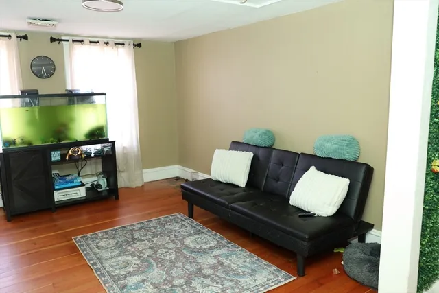 a view of a dining room with furniture and wooden floor